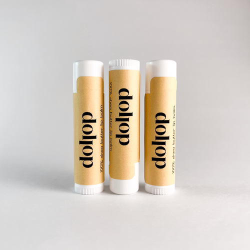 Three dollop lip balm tubes on a light gray background