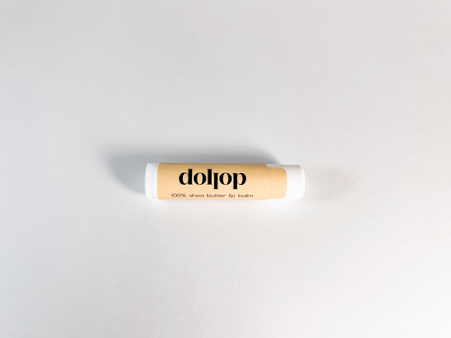 Dolpop lip balm on a light gray background
